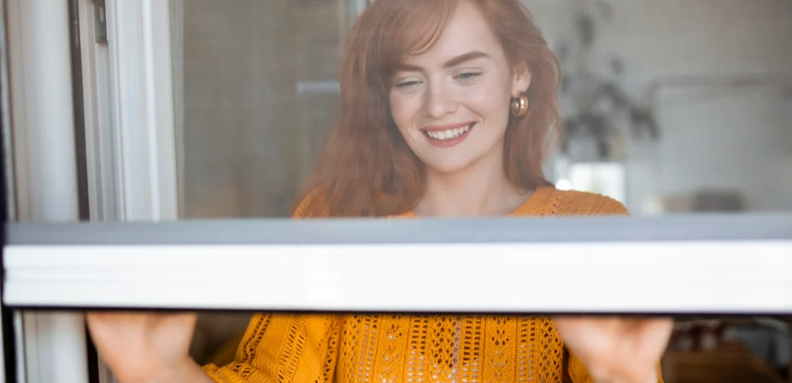 woman_standing_on_window